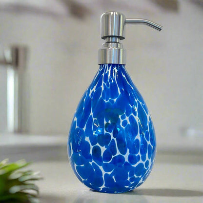 blue and white patterned soap dispenser with silver pump on bathroom counter