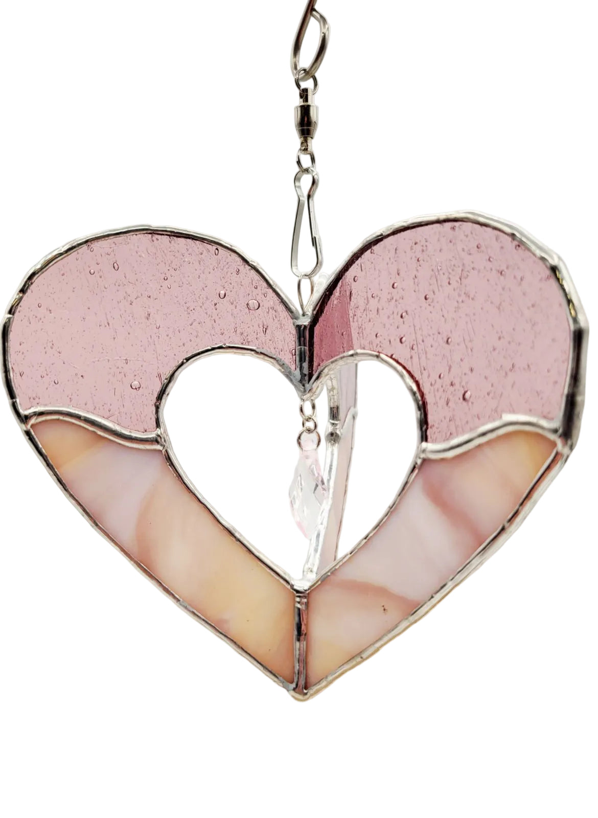 Heart-shaped stained glass window hanging with pink and white colors on a light gray background