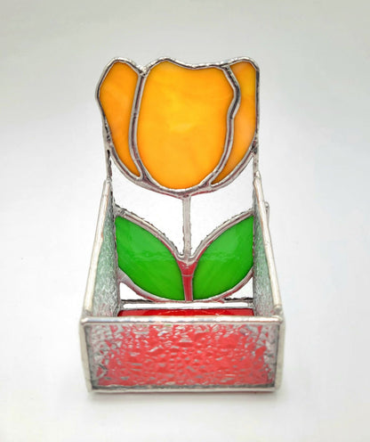 Stained glass tulip with orange flower and green leaves on a white background